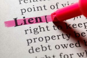 The word lien being hiligthed in a dictionary.