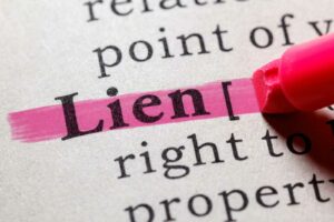 The word lien being hiligthed in a dictionary.